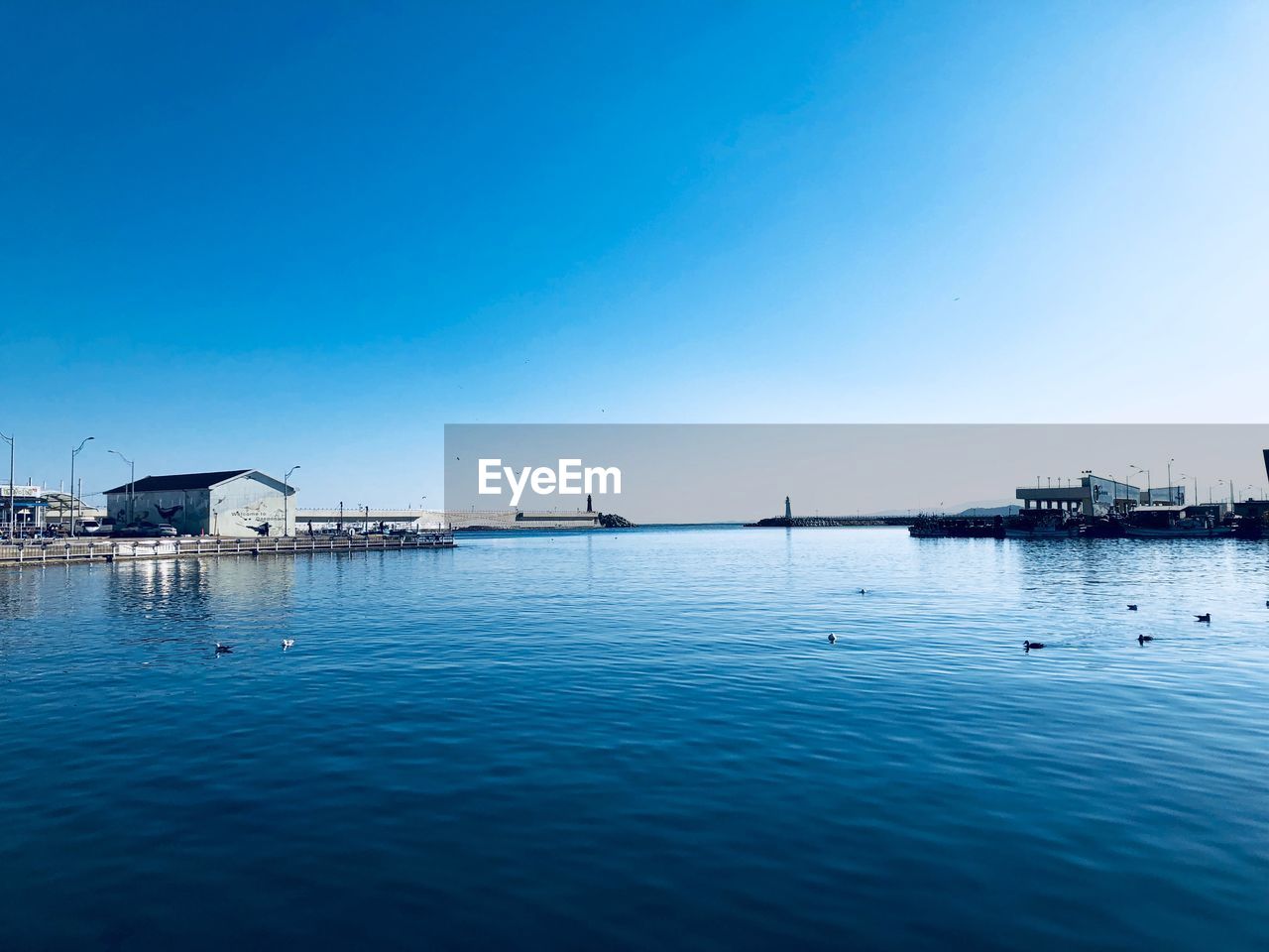 Scenic view of sea against clear blue sky