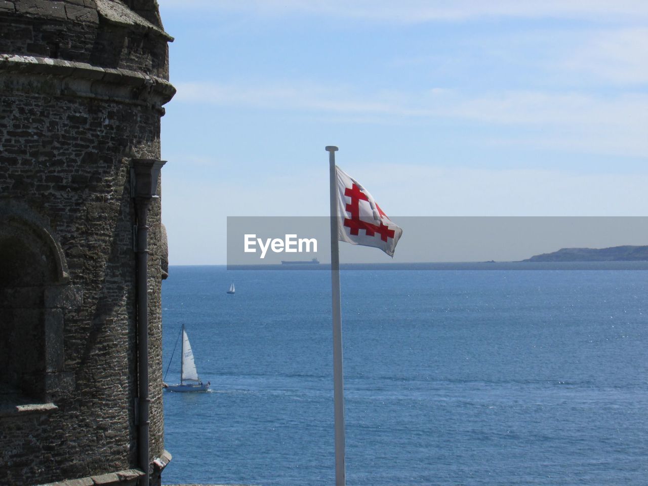 Flags on sea against sky