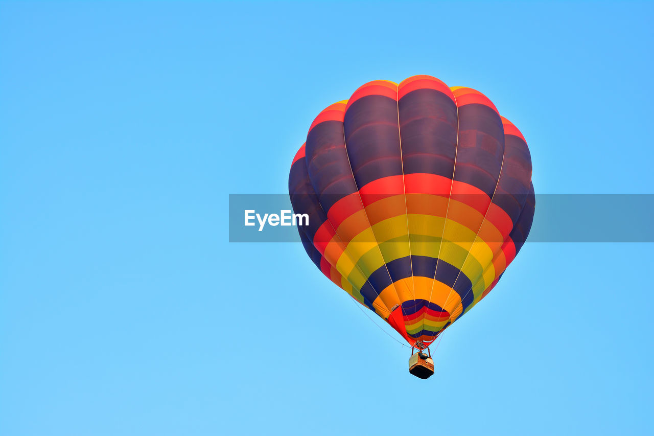 Low angle view of hot air balloon against blue sky