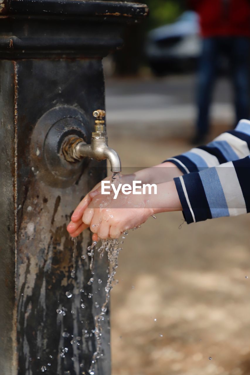 Close-up of hand holding water fountain