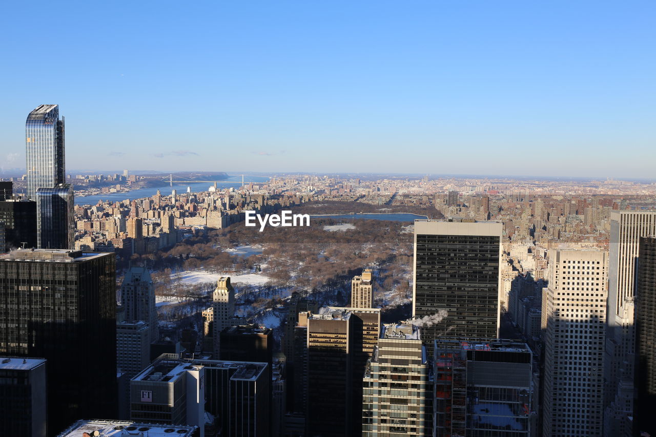 HIGH ANGLE VIEW OF BUILDINGS AGAINST CLEAR SKY