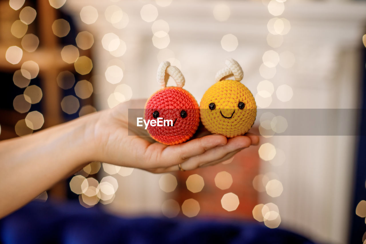 cropped hand of woman holding christmas tree