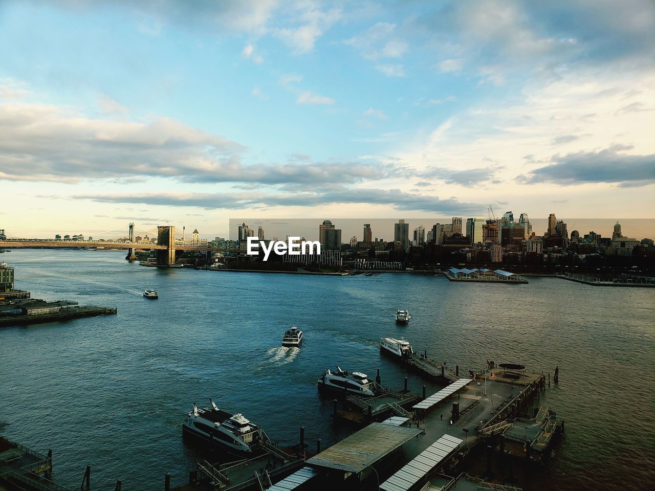 High angle view of river and city buildings against sky