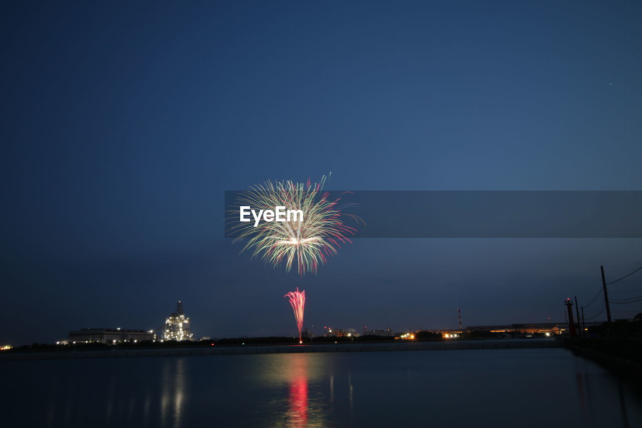 FIREWORK DISPLAY AGAINST SKY