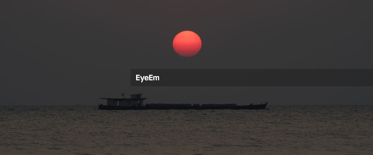 Scenic view of sea against sky at sunset