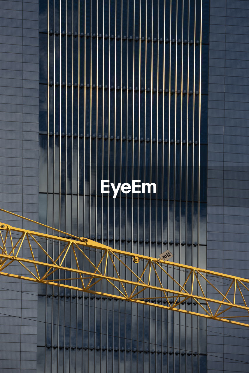 Metal railing of modern building and crane