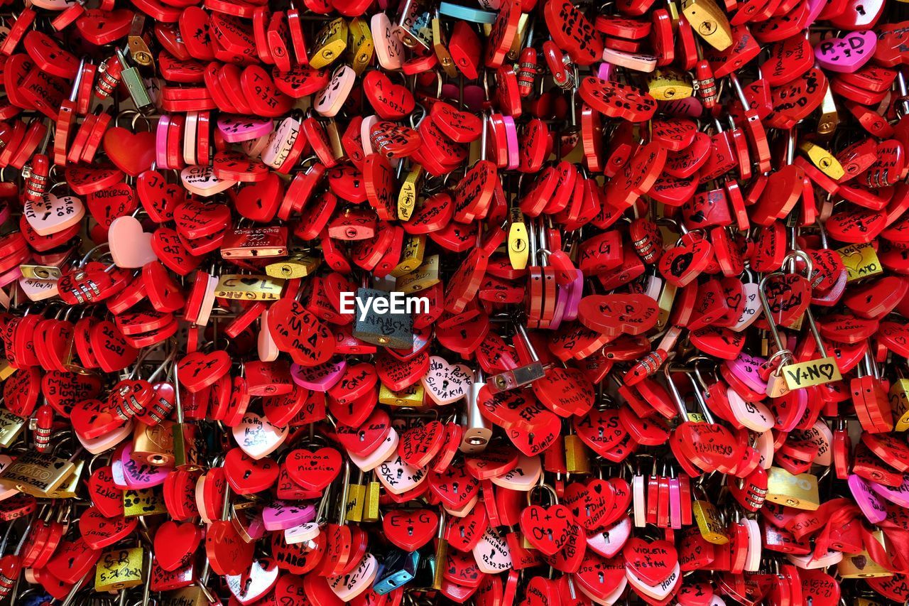 Full frame shot of red colored locks on a fence of romeo and juliet