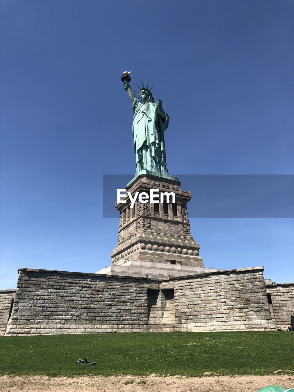 Low angle view of statue against blue sky