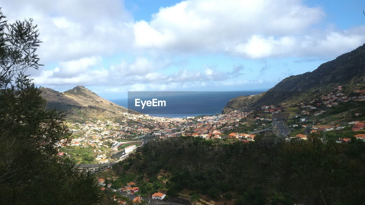 Scenic view of mountains and sea against sky