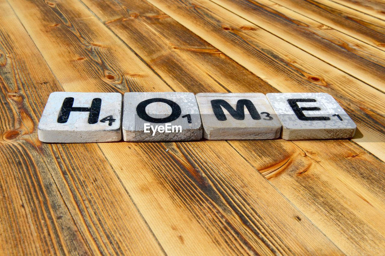 High angle view of text blocks on wooden table