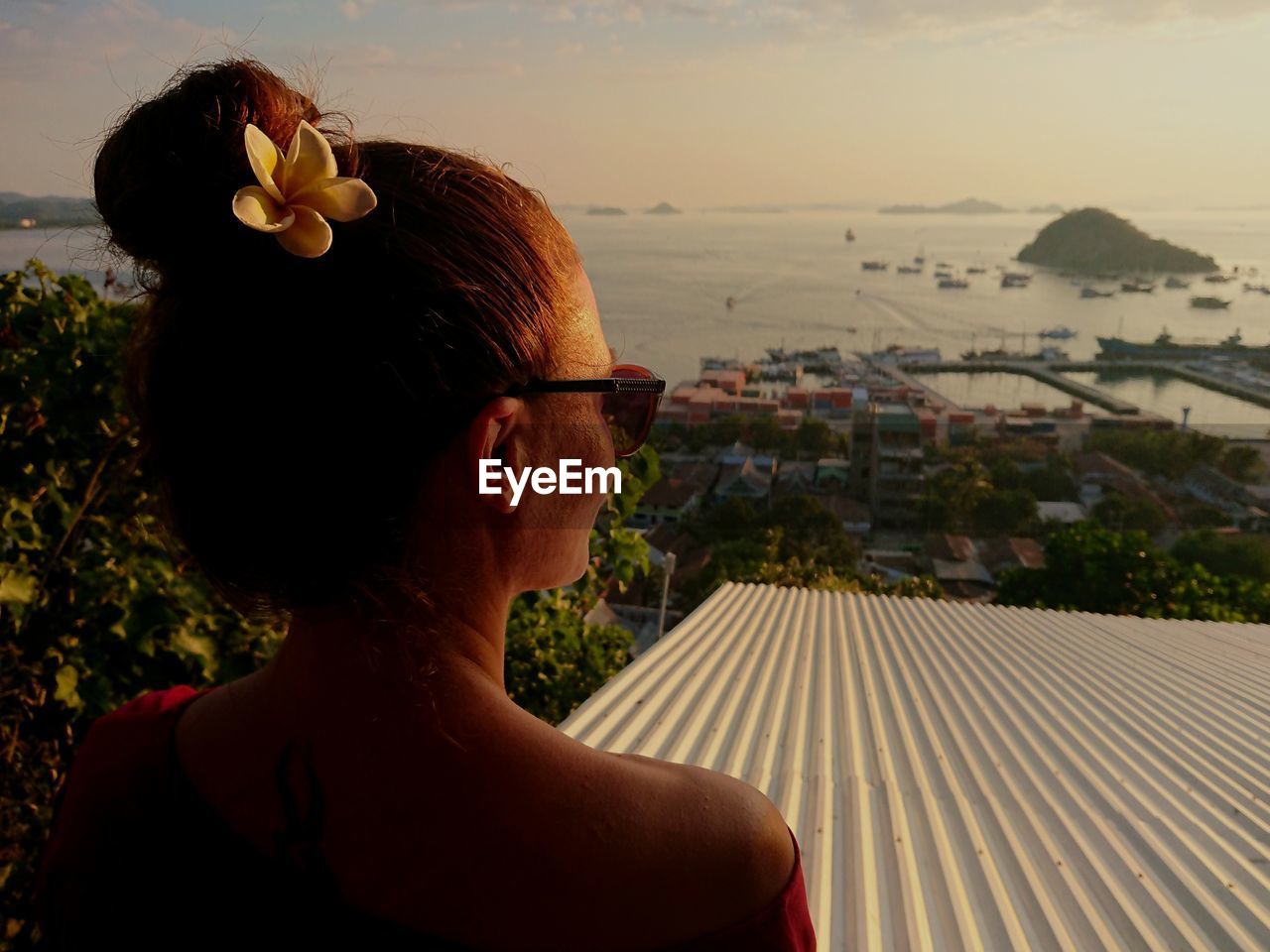 Mid adult woman looking at sea during sunset