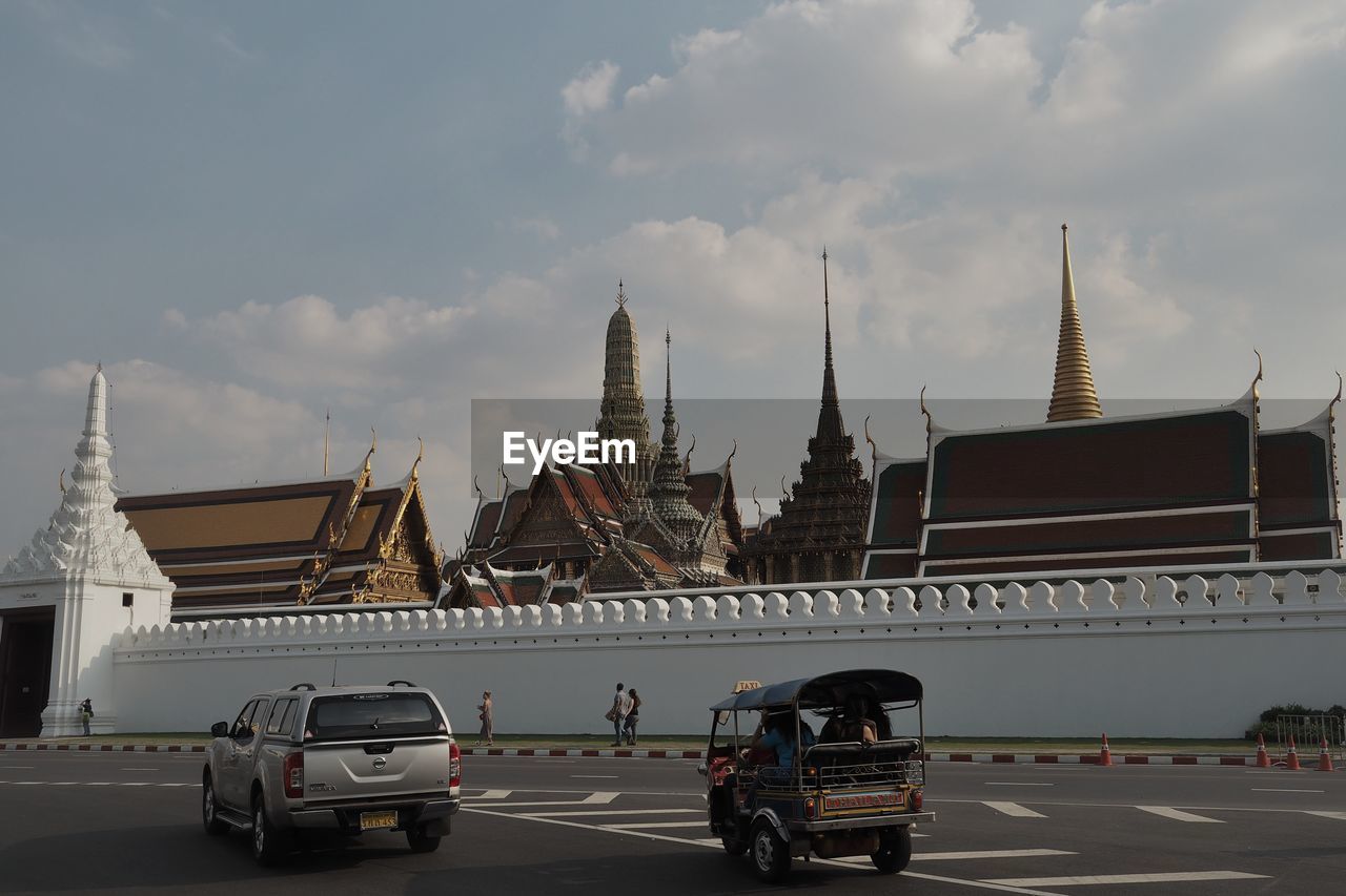 CARS ON ROAD AGAINST BUILDINGS