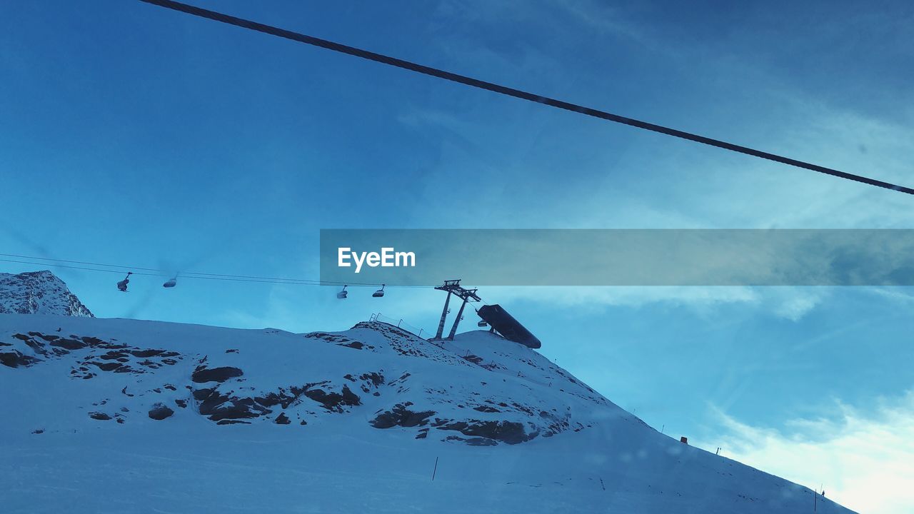 LOW ANGLE VIEW OF SNOW ON MOUNTAIN AGAINST SKY