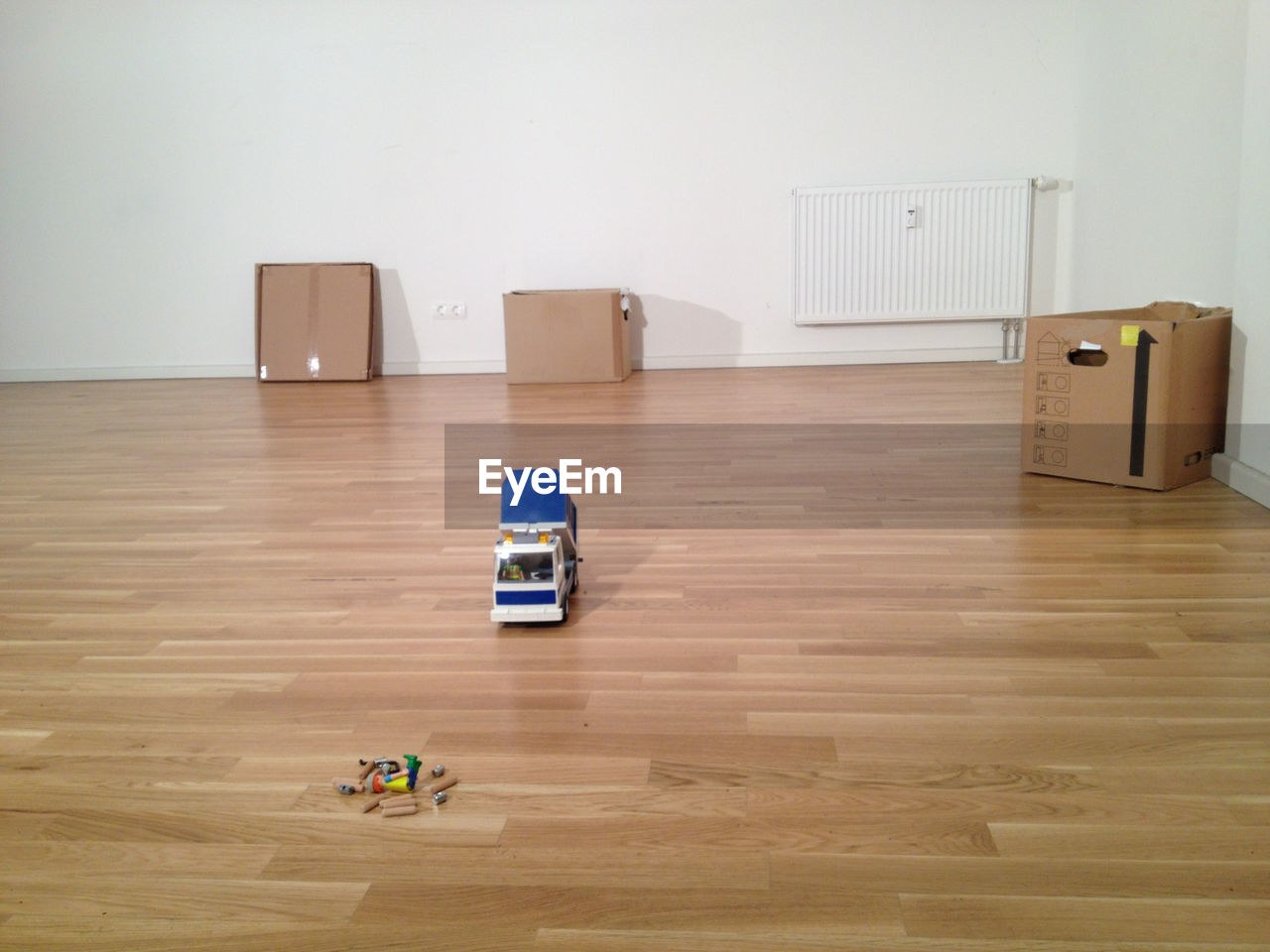 Toys and crayons on hardwood floor