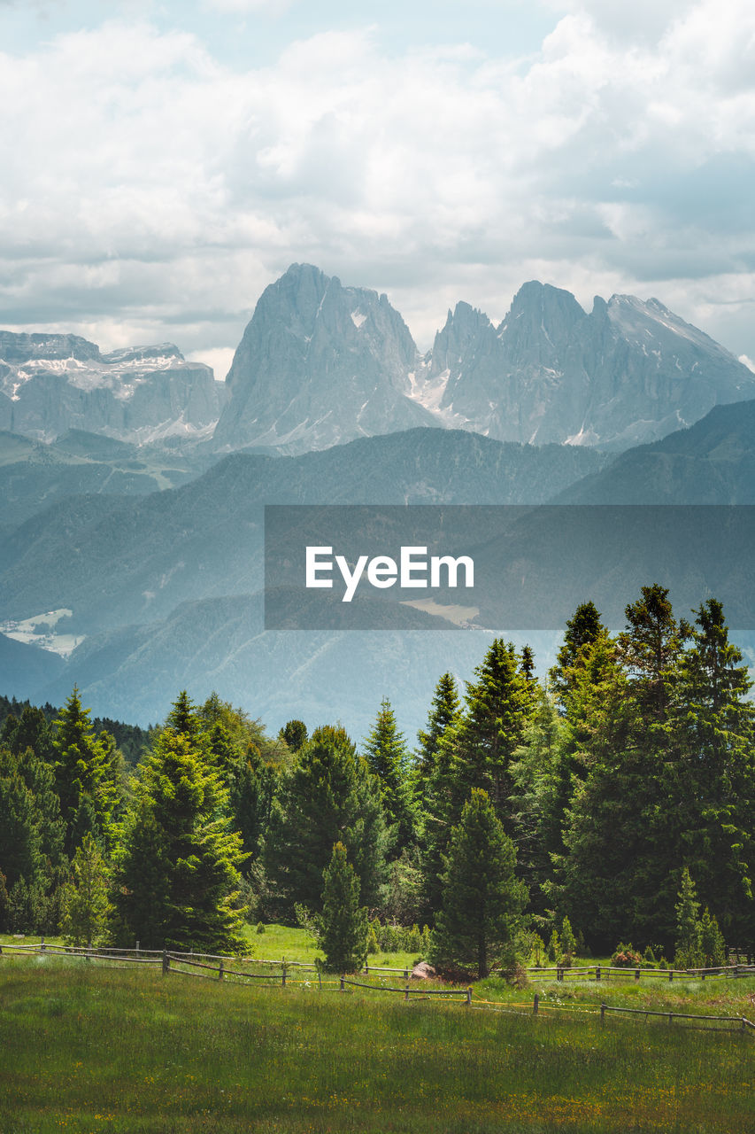 Scenic view of mountains against cloudy sky