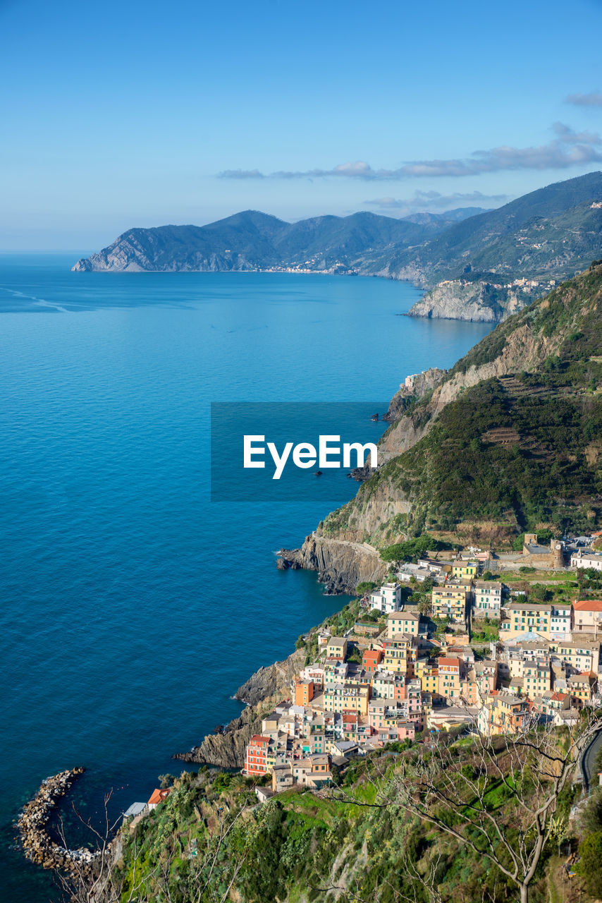 High angle view of townscape by sea against sky