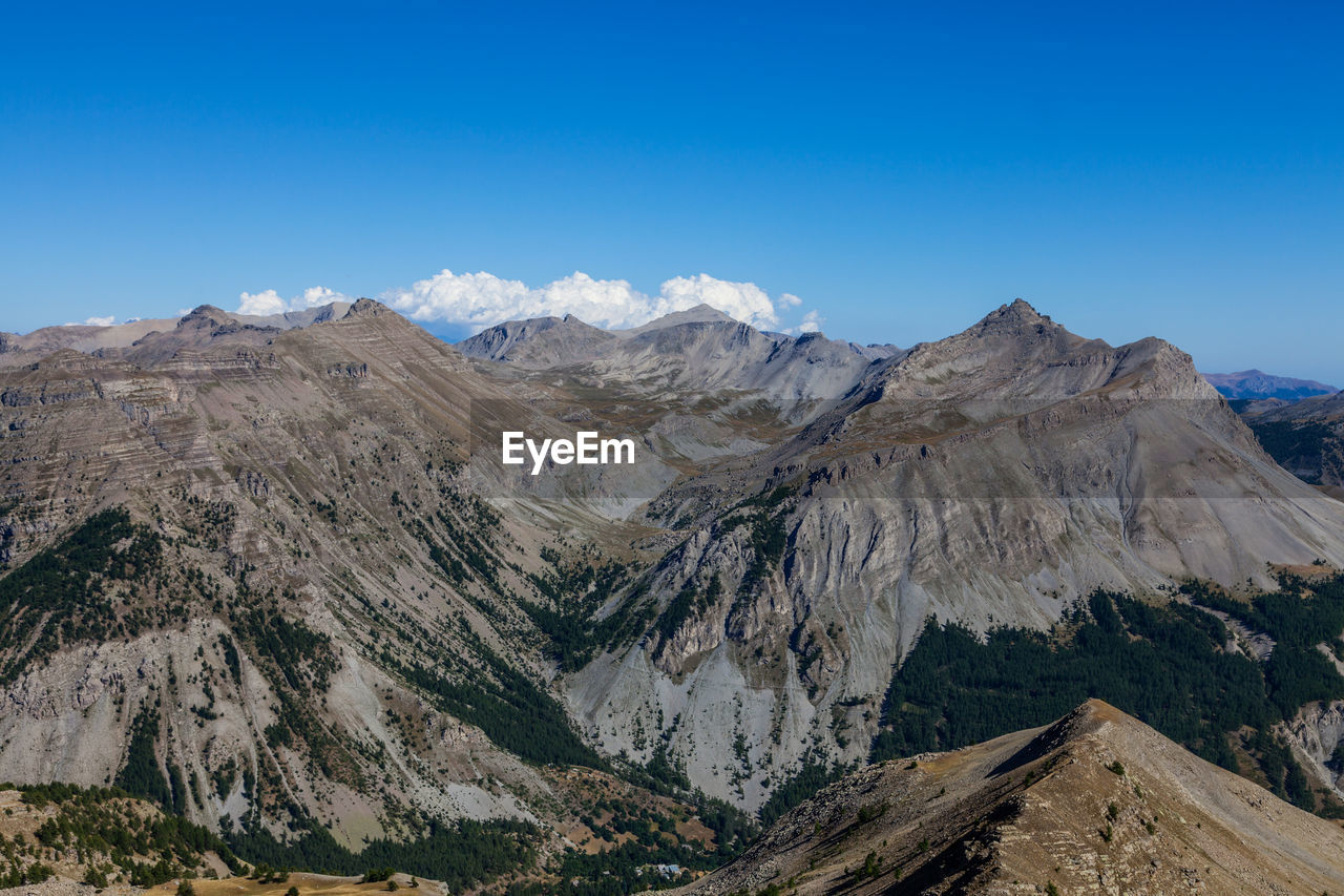 Scenic view of mountains against clear blue sky