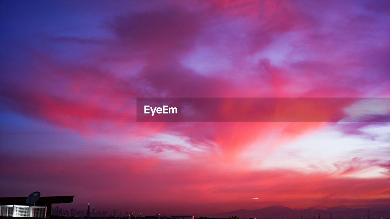 LOW ANGLE VIEW OF DRAMATIC SKY OVER SILHOUETTE TREES