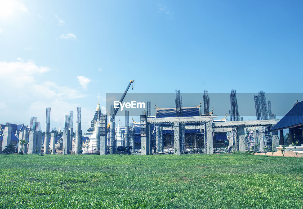 PANORAMIC SHOT OF CRANES AGAINST SKY