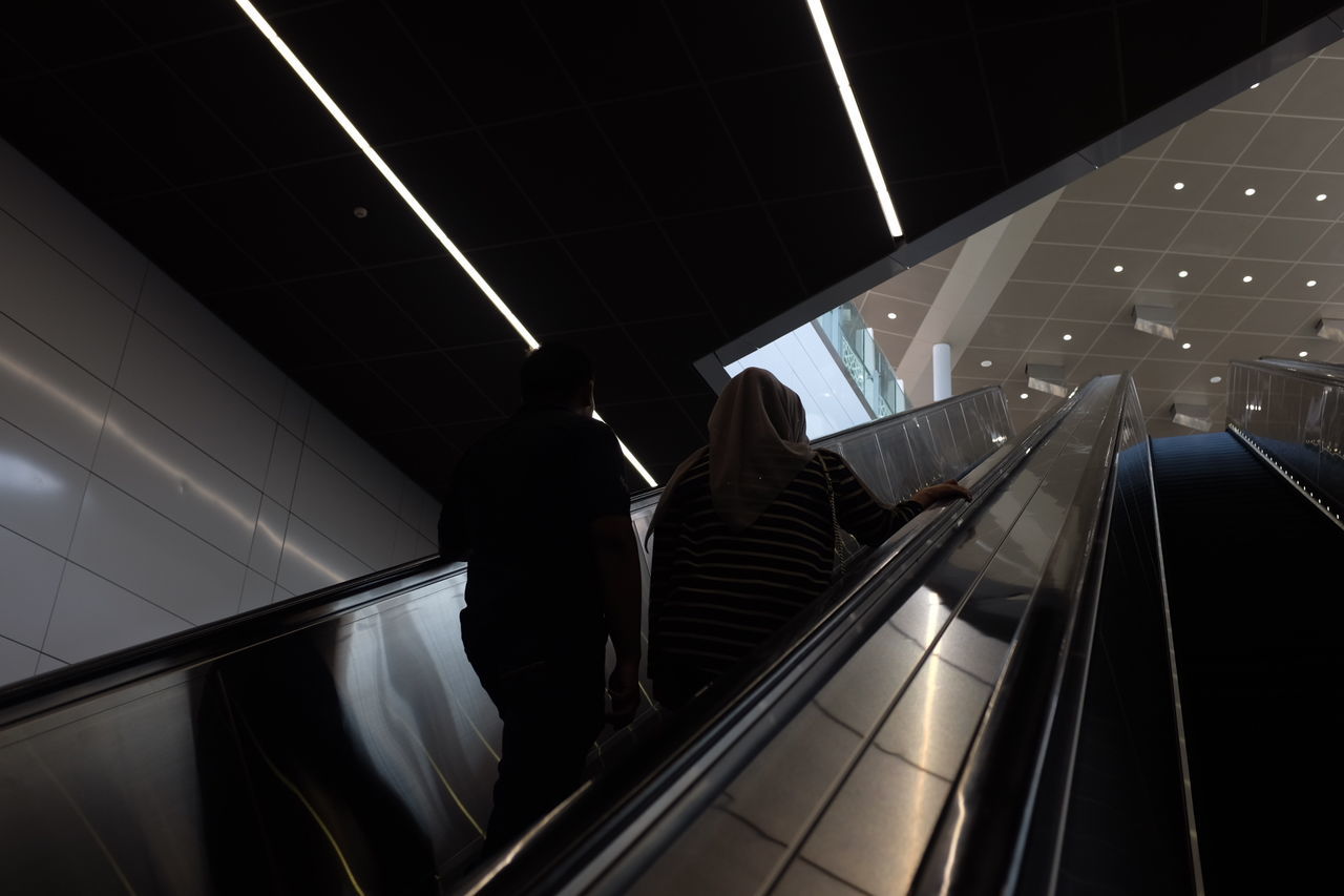 PEOPLE ON ESCALATOR IN MUSEUM