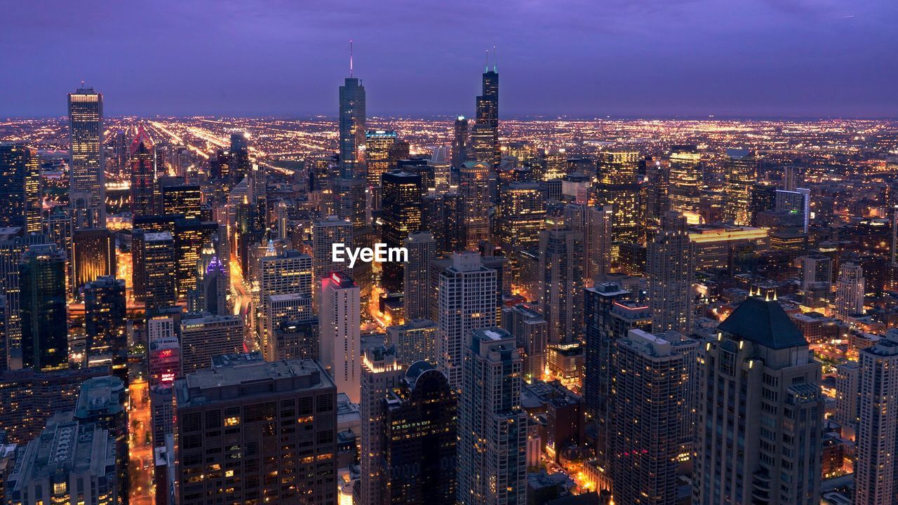 Aerial view of illuminated city at night