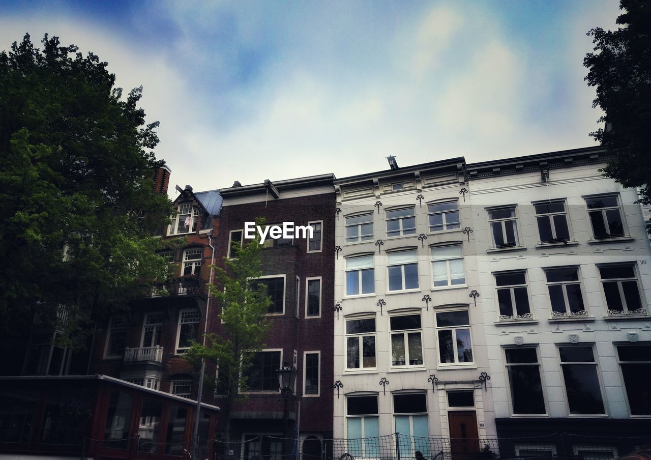 Low angle view of building against cloudy sky