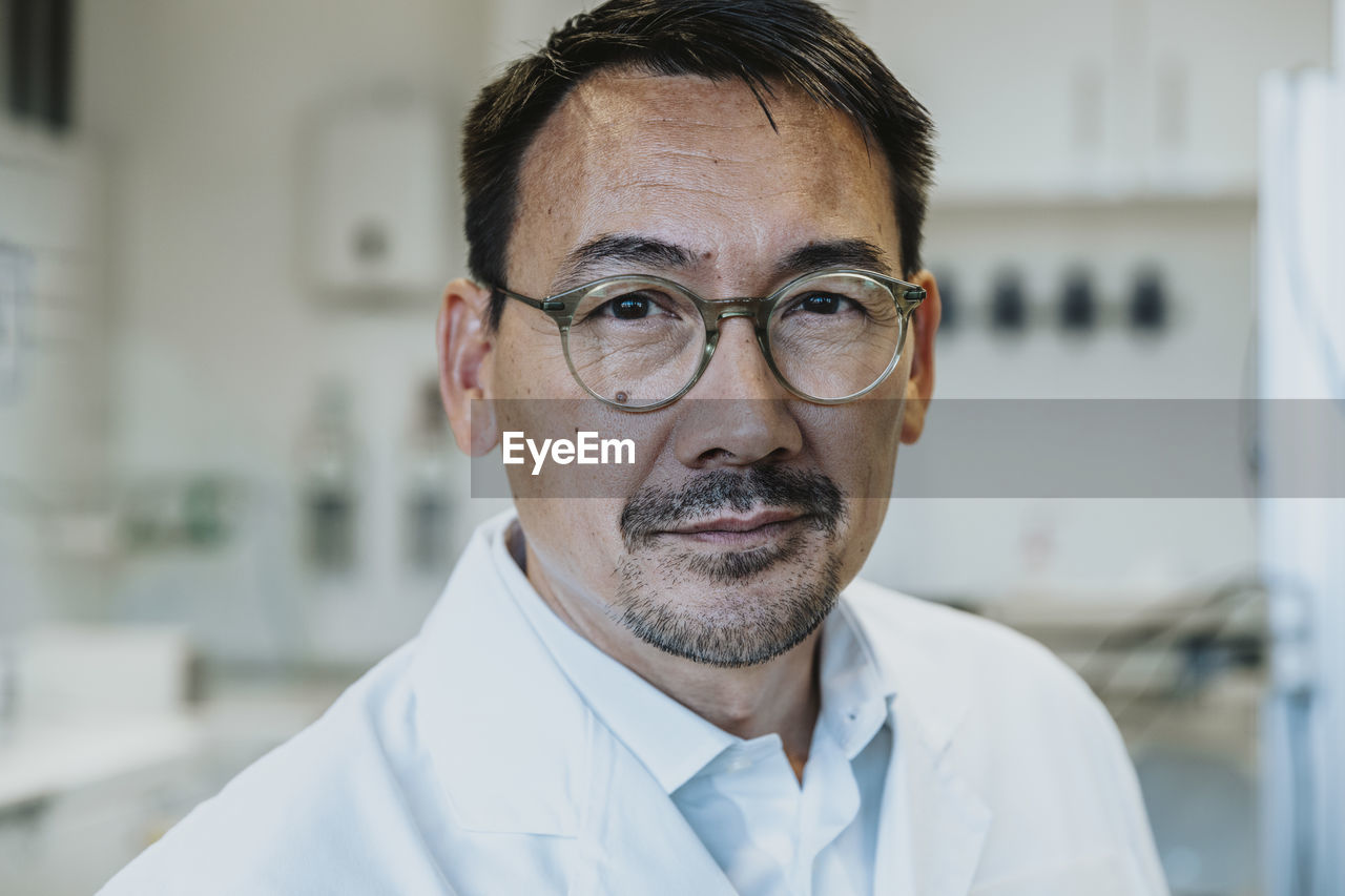 Man wearing eyeglasses standing at laboratory