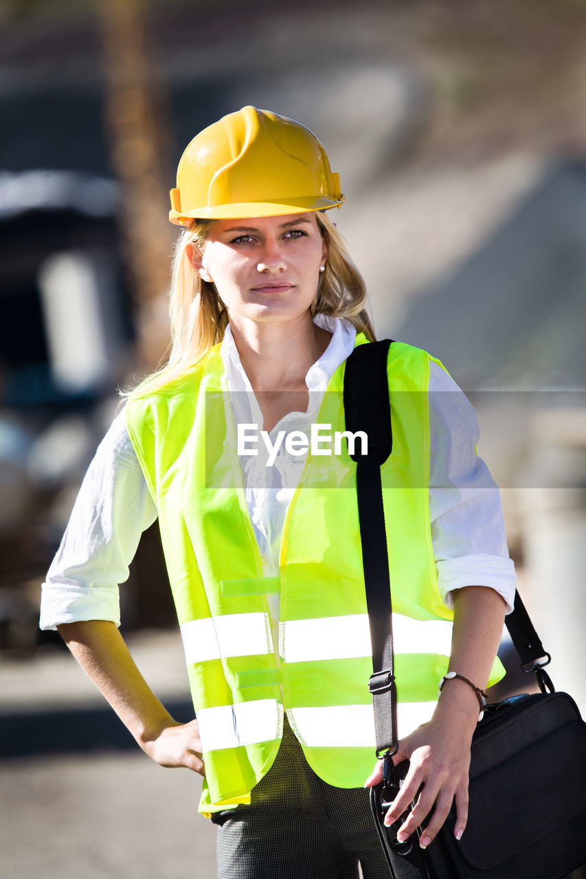 Architect wearing reflective clothing standing outdoors