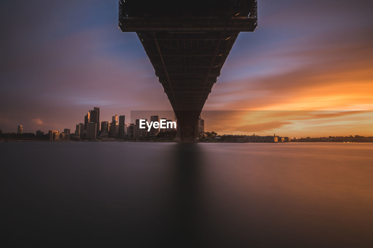 ILLUMINATED CITYSCAPE AGAINST SKY AT NIGHT