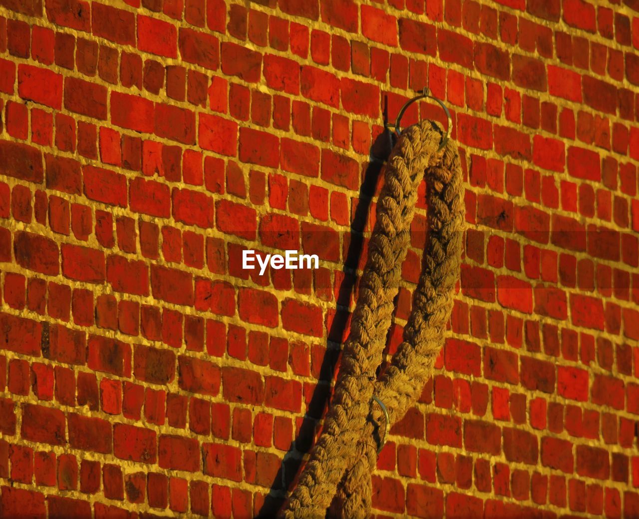 Close-up of rope on brick wall