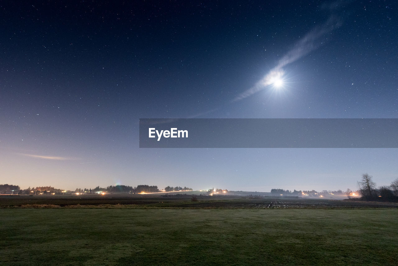 Scenic view of field against sky at night