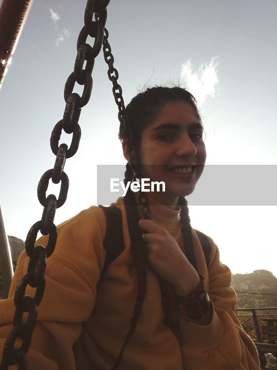 Portrait of smiling woman against sky