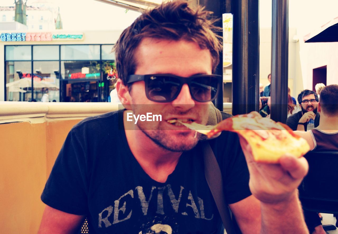 Young man having pizza in restaurant