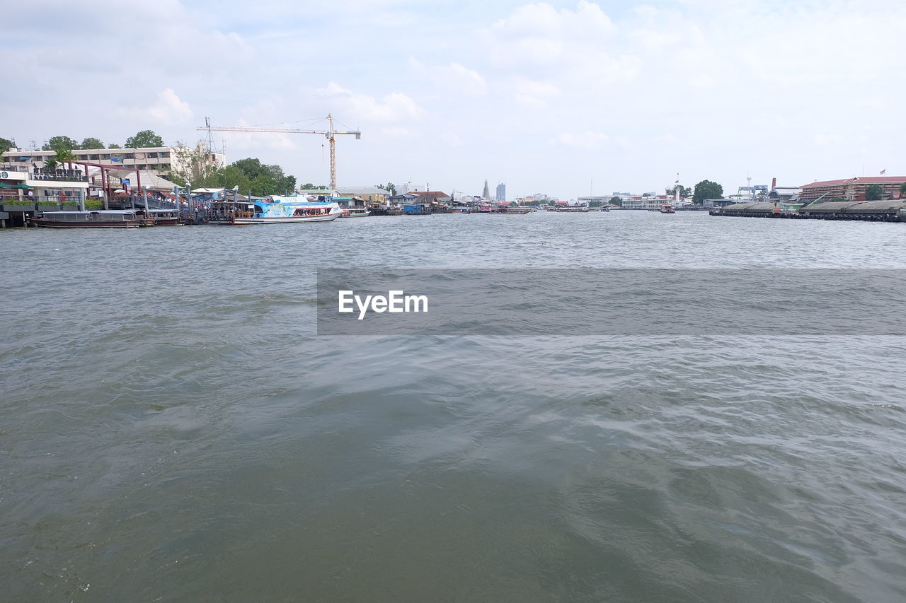 Scenic view of river against cloudy sky