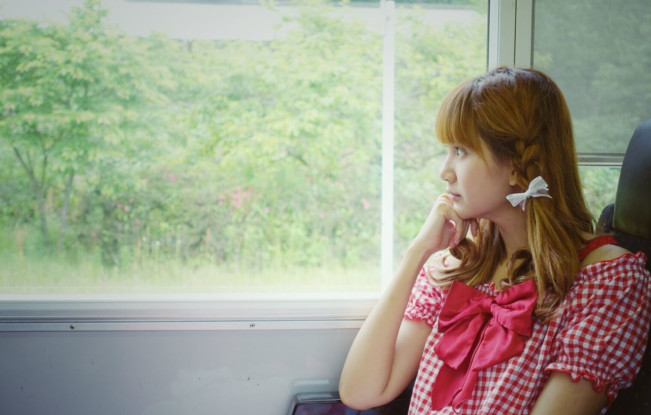 Thoughtful woman sitting in train