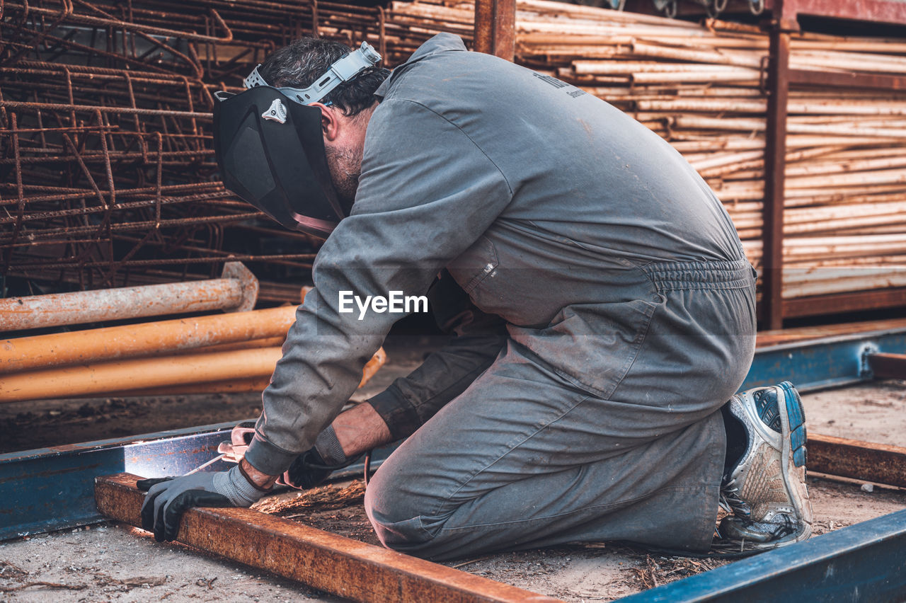 MAN WORKING ON METAL STRUCTURE