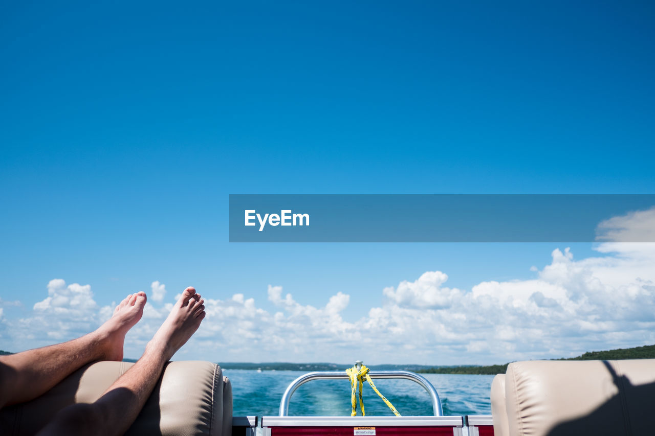 Teenager's feet in the air on a boat in kansas city