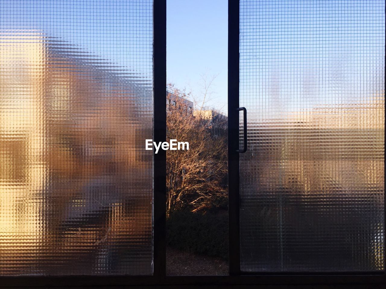 CLOSE-UP OF SILHOUETTE WINDOW AGAINST SUNSET