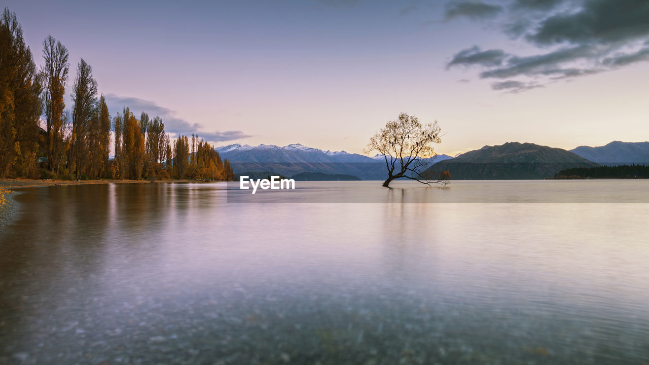 Scenic view of lake against sky during sunset