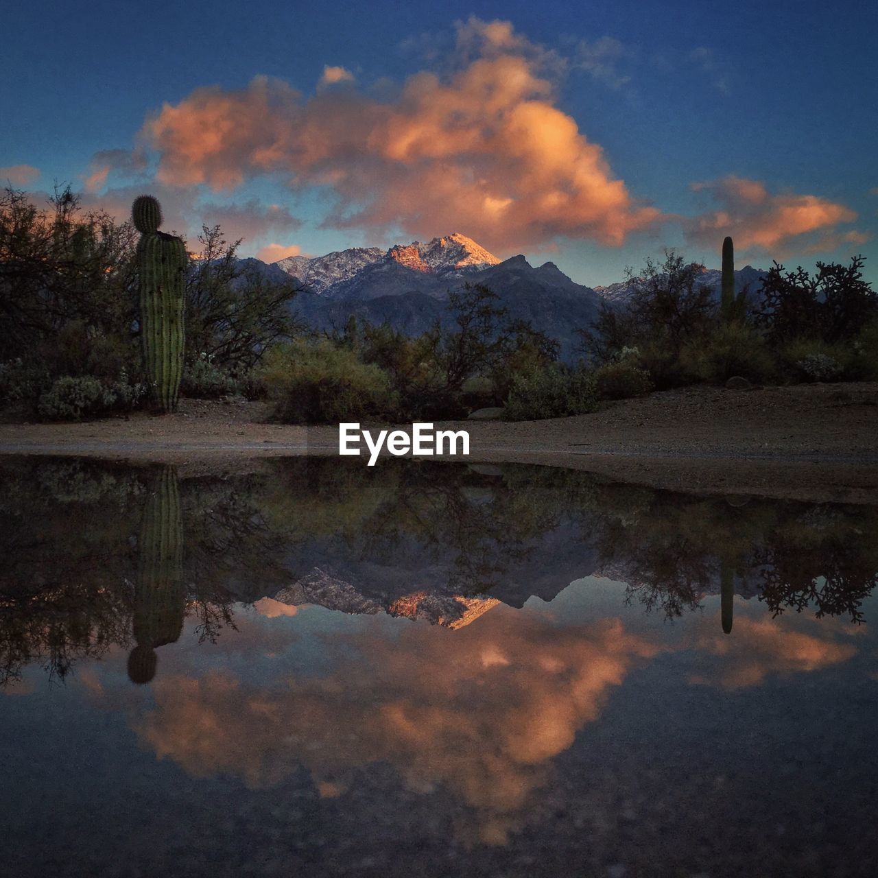 Scenic view of calm lake against cloudy sky