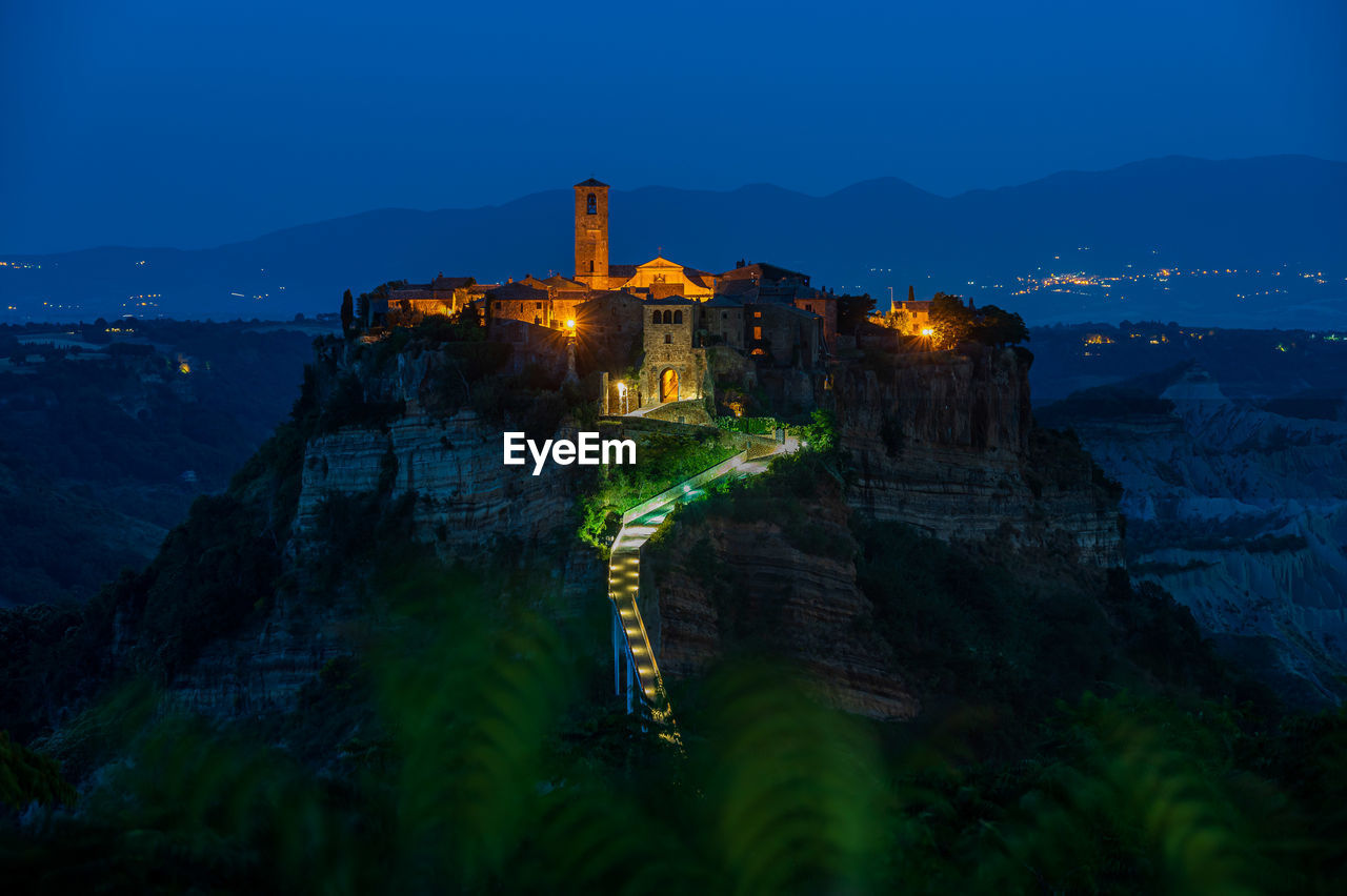 The ancient village of civita di bagnoregio, also called the diying city, in italy, at the blue hour
