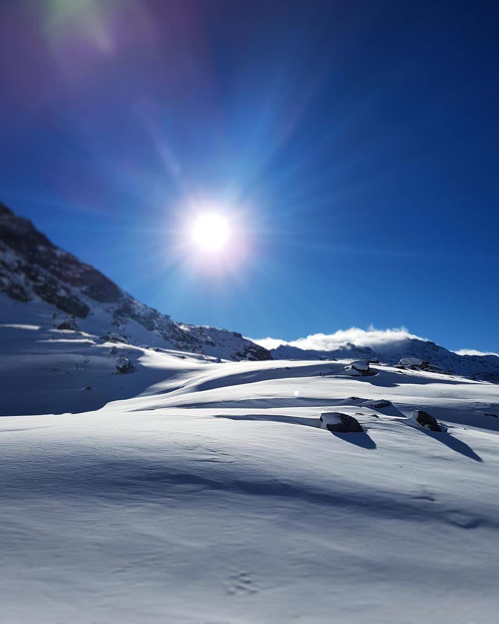 Frozen landscape against blue sky