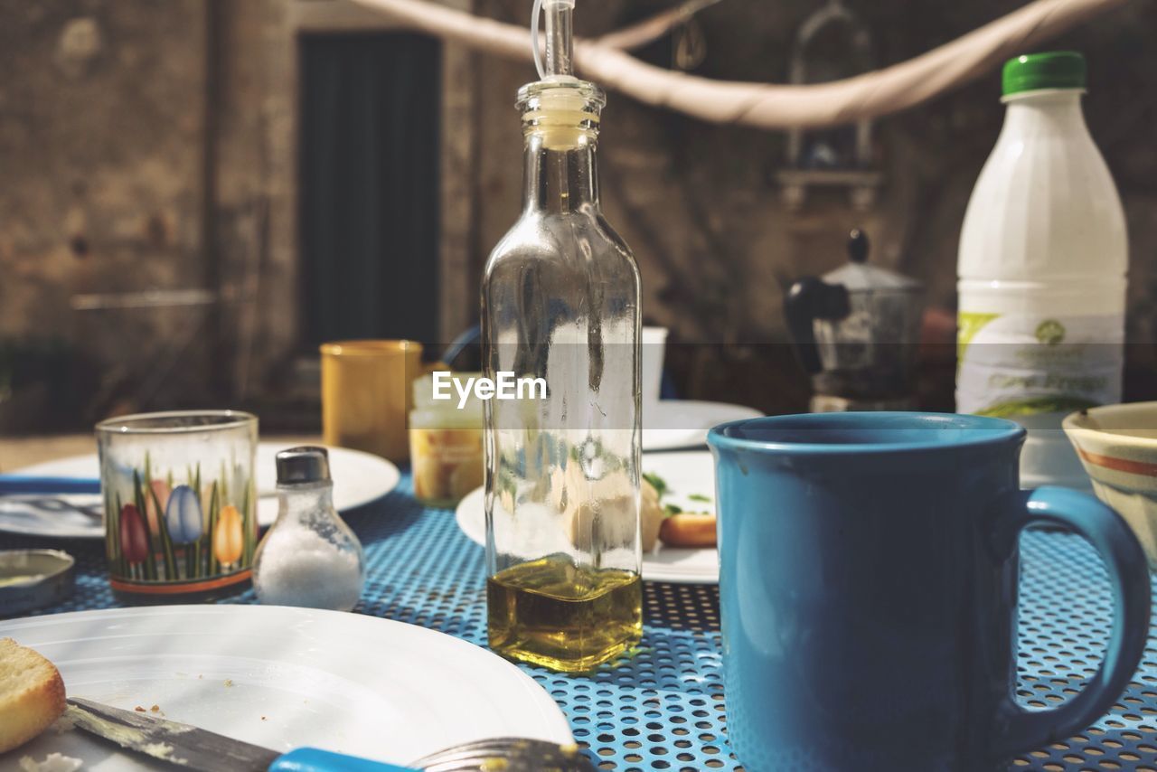 CLOSE-UP OF WINE BOTTLES ON TABLE AT BAR