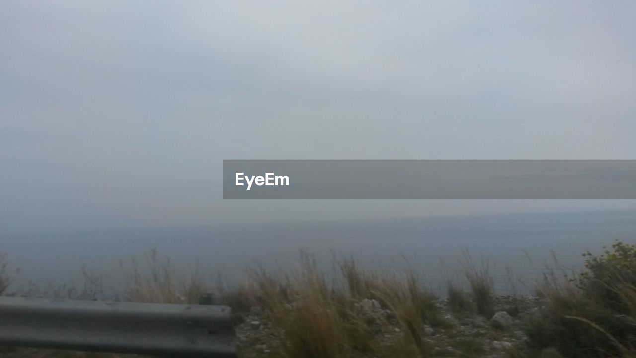 Scenic view of landscape against cloudy sky