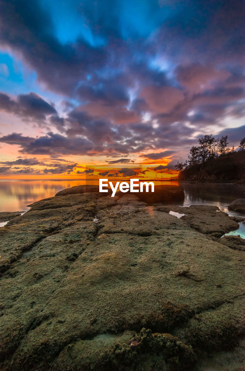 View of calm beach at sunset