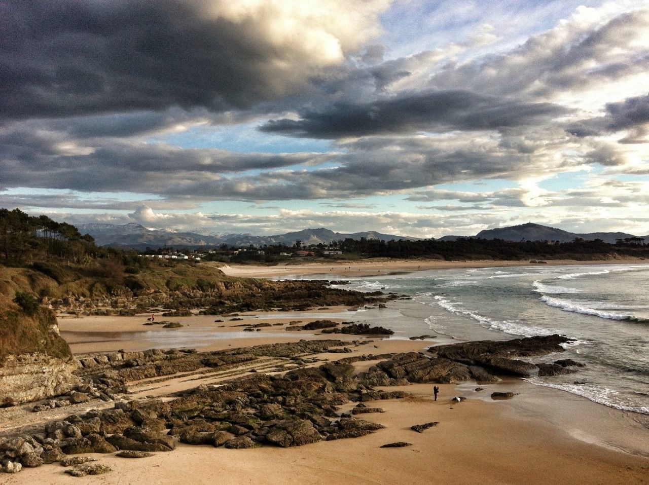 High angle view of beach below cloudy sky