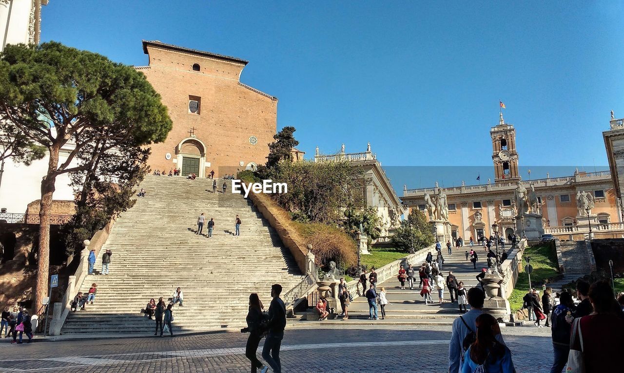 People walking in front of historical building