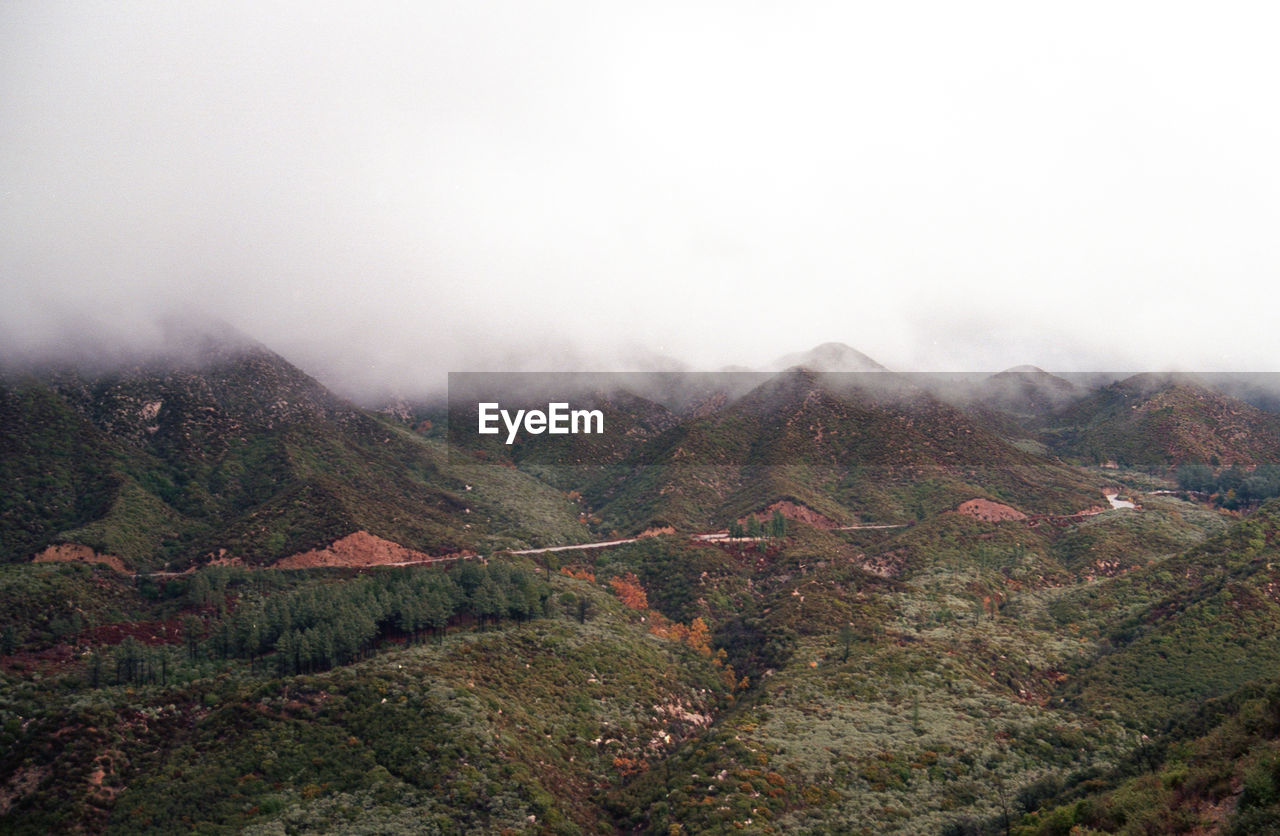 Scenic view of mountains against clouds