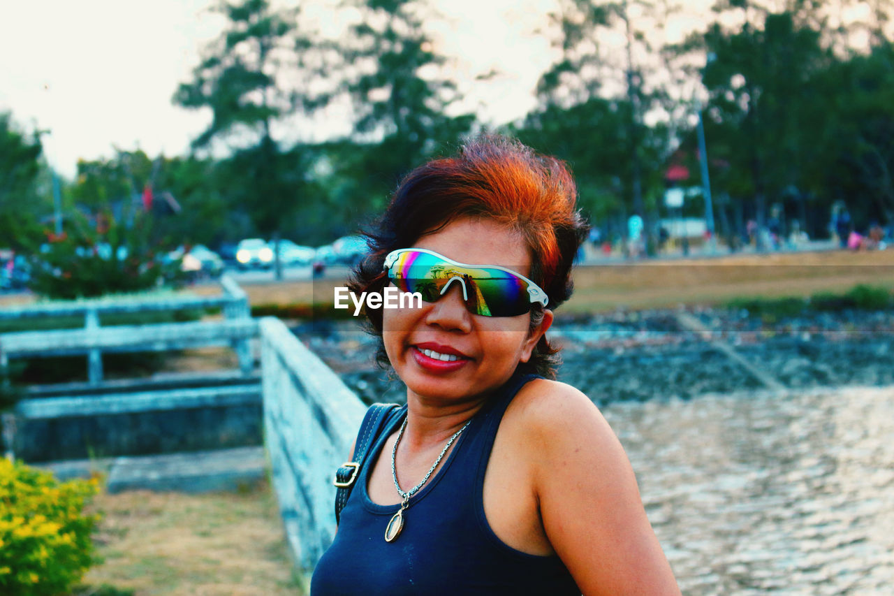 Portrait of woman wearing sunglasses standing outdoors