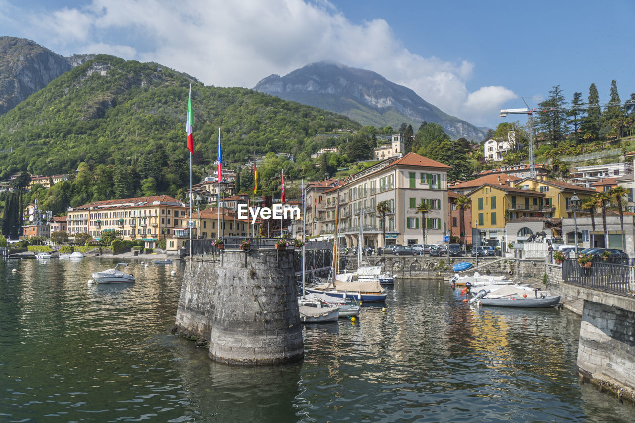 The beautiful port of menaggio with the colorful houses that are reflected on the water